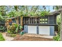 Ranch style home with mature landscaping and a two-car garage at 751 Pinellas Point S Dr, St Petersburg, FL 33705