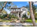 Two-story house with a walkway, landscaping, and a charming facade at 811 19Th N Ave, St Petersburg, FL 33704