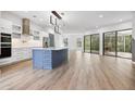 Modern kitchen with a large island and stainless steel appliances at 9116 Exposition Dr, Tampa, FL 33626