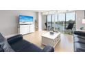 Relaxing living room with water views and comfy seating at 10355 Paradise Blvd # 207, Treasure Island, FL 33706