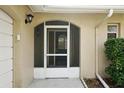 House entrance with a screened door and tiled flooring at 10704 Mira Vista Dr, Port Richey, FL 34668
