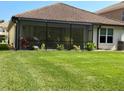 Spacious backyard with screened enclosure and lush green lawn at 10880 Cory Lake Dr, Tampa, FL 33647
