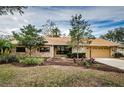 Charming stone house with a two-car garage and well-maintained landscaping at 12708 N 52Nd St, Temple Terrace, FL 33617