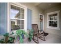 Front entry with rocking chair and potted plants at 13607 Circa Crossing Dr, Lithia, FL 33547