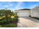 Two-car garage with a driveway and landscaping at 13607 Circa Crossing Dr, Lithia, FL 33547