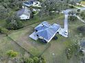 Aerial view showcasing the home's backyard, side yard, and a large grassy area at 13653 Heritage Way, Sarasota, FL 34240
