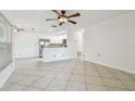 Open living space with tile floors connecting to the stainless steel kitchen appliances at 15107 Morning Dr, Lutz, FL 33559
