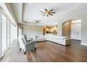 Spacious living room with hardwood floors, sectional sofa, and large windows at 1840 Douglas Ave, Dunedin, FL 34698