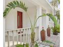 Front porch with red door and potted plants at 2077 5Th St, Sarasota, FL 34237