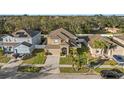 Aerial view of a residential area with houses, trees, and street at 2307 Dakota Rock Dr, Ruskin, FL 33570