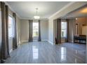 Formal dining room with large windows, neutral walls, and tile flooring at 26932 Sea Breeze Way, Wesley Chapel, FL 33544