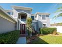 Front view of two-story house with gray siding, manicured landscaping, and a walkway at 26932 Sea Breeze Way, Wesley Chapel, FL 33544