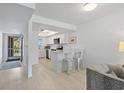 Modern white kitchen with breakfast bar and stainless steel appliances at 4520 Overlook Ne Dr # 238, St Petersburg, FL 33703