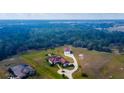 Stunning aerial view of a sprawling home on a large lot with mature trees at 6367 Foxbrook Trl, Parrish, FL 34219