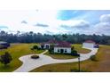 Beautiful single-Gathering home with a large front yard, circular driveway, and detached garage at 6367 Foxbrook Trl, Parrish, FL 34219