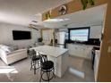 Modern kitchen with white cabinets, quartz countertops, and stainless steel appliances at 7524 Vienna Ln, Port Richey, FL 34668