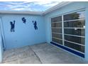 Side entry with unique wall decor and access to the backyard at 7524 Vienna Ln, Port Richey, FL 34668