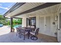 Relaxing patio with outdoor dining set, adjacent to the pool at 8532 Kumquat Ave, Seminole, FL 33777