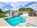 Sparkling, rectangular pool with a large patio area at 8532 Kumquat Ave, Seminole, FL 33777