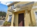 Front entrance of yellow townhome at 10805 Keys Gate Dr, Riverview, FL 33579