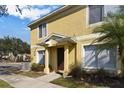 Front entrance of yellow townhome at 10805 Keys Gate Dr, Riverview, FL 33579