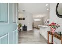 Welcoming foyer featuring wood-look floors, a view of the dining area, and an open floor plan at 11125 Callisia Dr, Odessa, FL 33556
