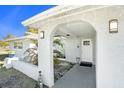 Inviting covered entryway with arched walkway leading to front door at 11828 Bingham Dr, Port Richey, FL 34668