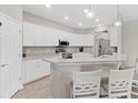 Modern kitchen with white cabinets and granite countertops at 16120 67Th E Ct, Parrish, FL 34219