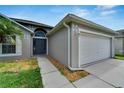 Newly painted exterior with a welcoming front door at 1613 Alhambra Crest Dr, Ruskin, FL 33570