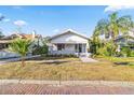 Updated bungalow exterior with a spacious lawn at 235 11Th Ne Ave, St Petersburg, FL 33701