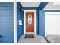 Inviting orange front door with glass accents and a stylish hello mat at 3621 19Th Street N, St Petersburg, FL 33713