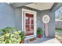 Inviting front door entrance with home decor and potted plants at 410 Pine Pointe Ct, Seffner, FL 33584