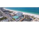 Aerial view of beachfront property with tennis courts and pool at 4950 Gulf Blvd # 401, St Pete Beach, FL 33706