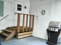 Small back patio with wooden steps and grill at 5335 Fairfield S Ave # 78, Gulfport, FL 33707