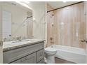 Updated bathroom with gray vanity, granite countertop, and beige tile shower/tub combo at 806 E Laura St, Plant City, FL 33563