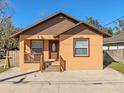 Newly built home with brown and tan exterior, a wooden deck, and a small yard at 806 E Laura St, Plant City, FL 33563
