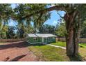 Charming green house with metal roof and spacious yard at 1202 S Walker St, Plant City, FL 33563