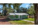 Newly renovated green house with metal roof and walkway at 1202 S Walker St, Plant City, FL 33563