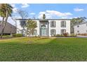 Two-story white brick home with a lush green lawn at 1330 Snell Isle Ne Blvd # 4, St Petersburg, FL 33704