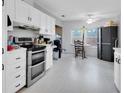 White kitchen with stainless steel appliances and eat-in area at 275 Pelican Dr N, Oldsmar, FL 34677