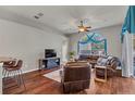 Gathering room with leather furniture, hardwood floors, and large windows at 27544 Kirkwood Cir, Wesley Chapel, FL 33544