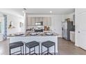 Modern kitchen with island, granite countertops, and stainless steel appliances at 36101 Sunflower Hill Dr, Zephyrhills, FL 33541