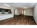 Modern kitchen with dark cabinetry, stainless steel appliances, and breakfast bar at 3843 Laslo Ave, North Port, FL 34287