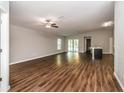 Spacious living room featuring wood-look flooring and sliding glass doors at 3843 Laslo Ave, North Port, FL 34287