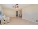 Living room with tile floors and access to the dining area at 7061 Denmark St, Englewood, FL 34224