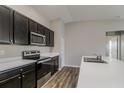 Modern kitchen featuring dark brown cabinets, stainless steel appliances, and white countertops at 849 Haleybury St, Port Charlotte, FL 33948