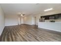 Spacious living room with wood-look flooring and an open layout at 849 Haleybury St, Port Charlotte, FL 33948