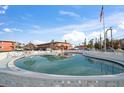 Kidney-shaped pool with surrounding patio furniture at 8565 W Gulf Blvd # 17S, Treasure Island, FL 33706