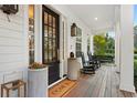 Inviting front porch with rocking chairs, porch swing, and attractive landscaping at 120 25Th N Ave, St Petersburg, FL 33704