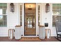 Inviting front porch with decorative planters and stylish lanterns flanking the doorway at 120 25Th N Ave, St Petersburg, FL 33704